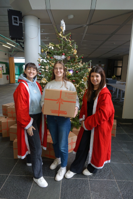 Schueler mit Paketen für die Weihnachtstrucker